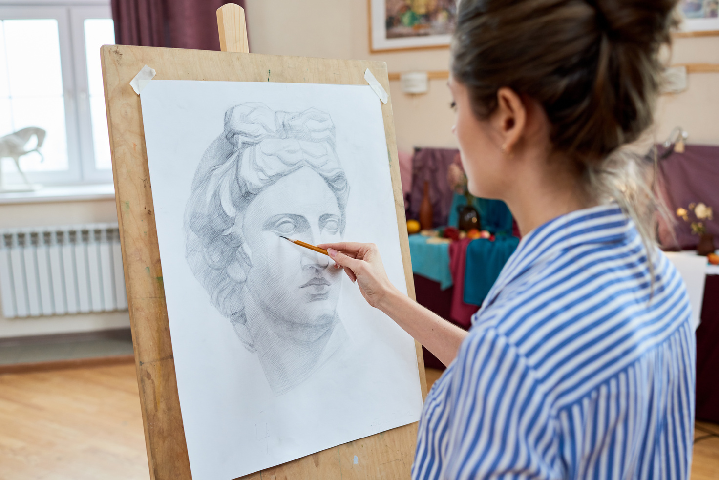 Concentrated artist drawing portrait